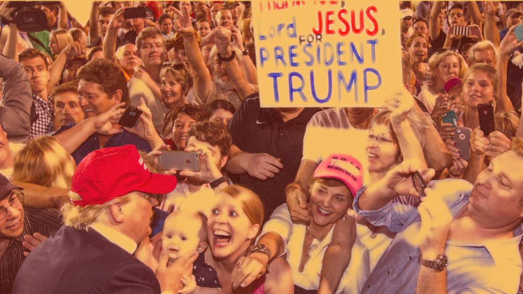 President Donald Trump greets supporters while one supporter holds a sign that says "Thank you Lord Jesus for President Trump."